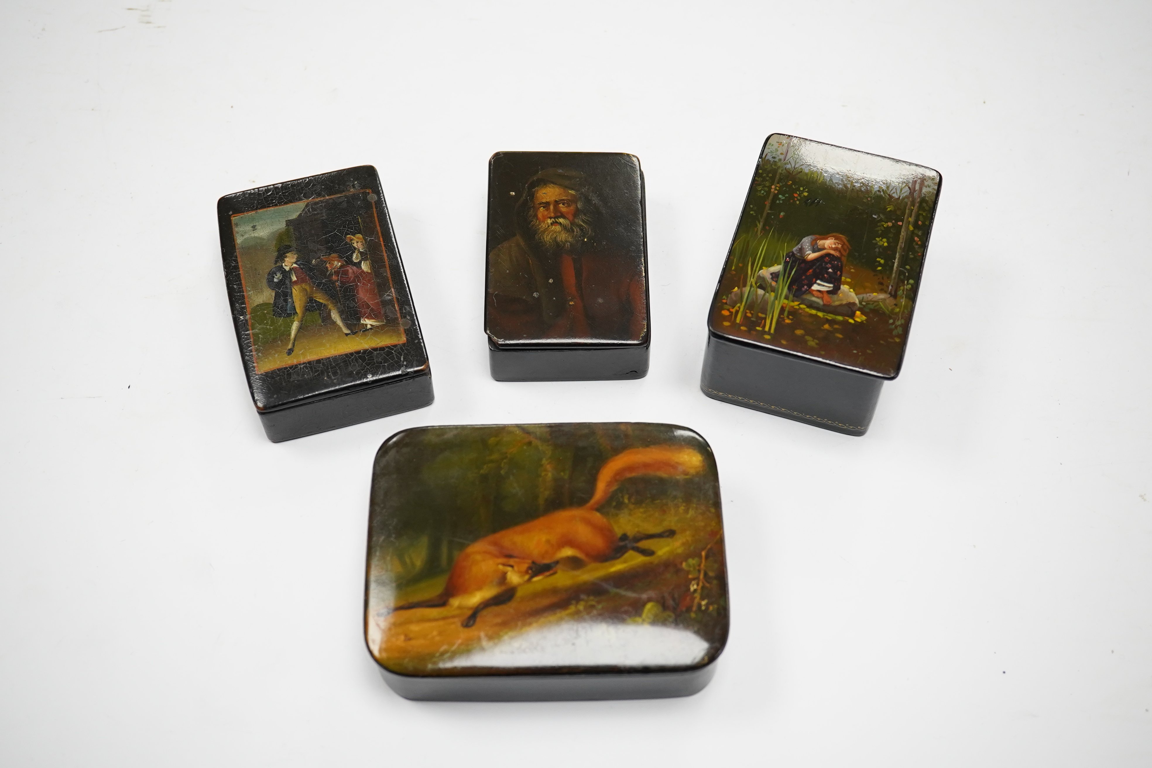 Four late 19th/early 20th century Russian lacquer boxes, largest 10.5cm. Condition - fair to good